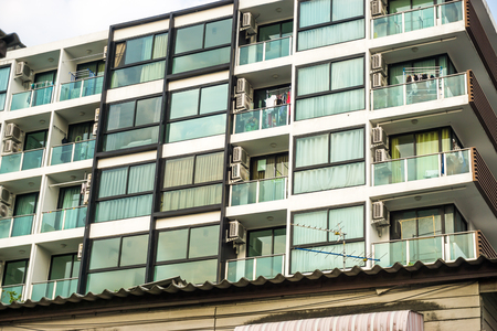 Modern condominium block building with blue sky cloud real estate business industryの写真素材