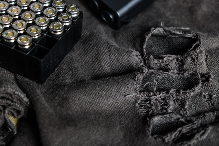 Polymer semi autometic 9mm gun with full metal jacket bullet on cloth background