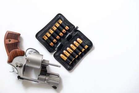 .44 revolver magnum gun with jacket hallow point bullet on white background