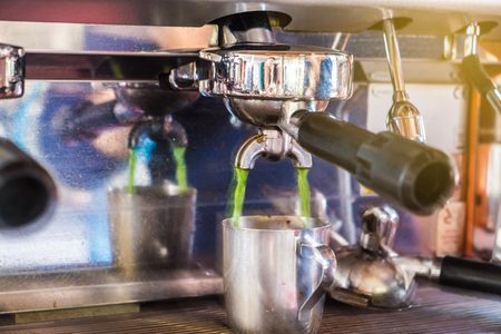 Coffee pouring machine with cup close upの写真素材