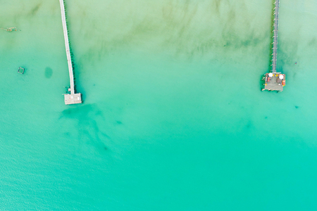 Sea wooden pier with boat on beach aerial viewの写真素材