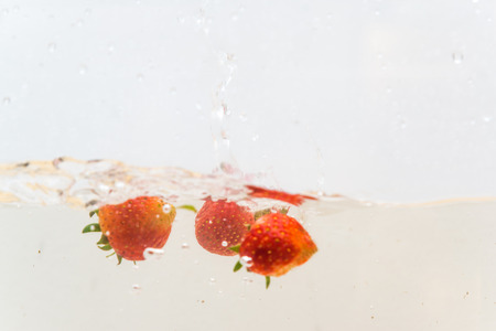 Fresh strawberry splash in water on white background, Fruit objectの写真素材