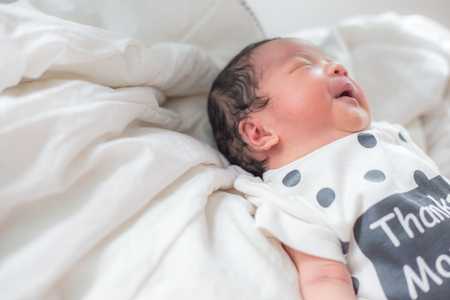 Adorable infant baby boy sleep on blanket relaxing timeの写真素材