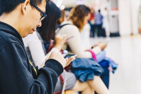 Business tourist man using smartphone in subway station, Technology conceptの写真素材