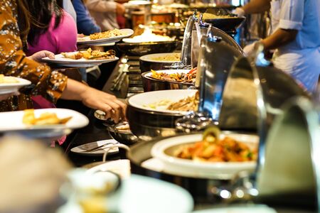 Hand of people take buffet food in hotel party, Food and drinkの写真素材