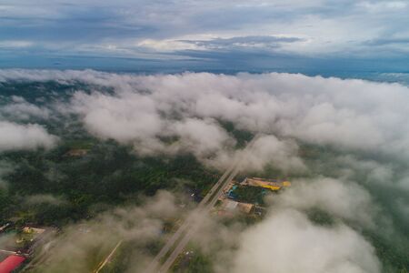 Green mountain tropical rain forest with fog in morning aerial viewの写真素材