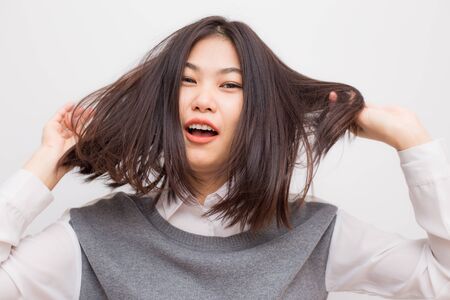 Healthy long hair and skin care concept women smiling on white backgroundの写真素材