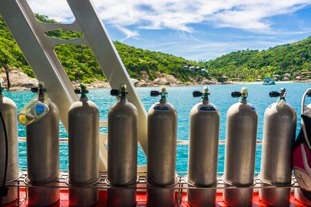 Diving oxygen air tank on boat in sea with equipmentの写真素材