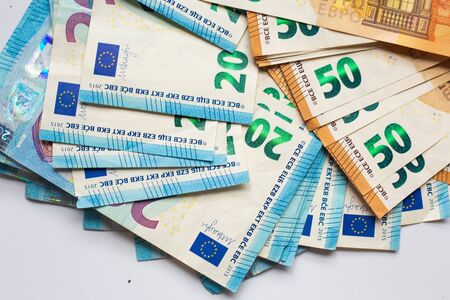 Pile of Euro money note bills on white background, European moneyの写真素材
