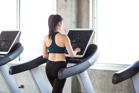 Group of running women on treadmill in fitness gym, Healthy concept