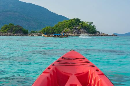 Kayak boat on sea shore to island summer sport vacationの写真素材