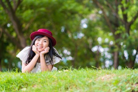 Joyful beautiful women relaxation lying on grass in parkの写真素材
