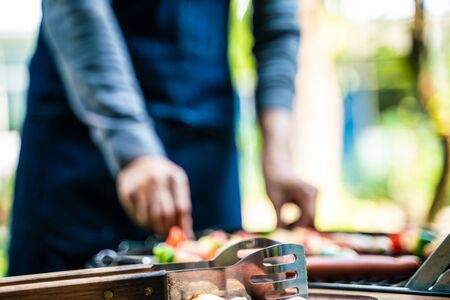 BBQ grilled party at outdoor garden hand close up friendship meeting