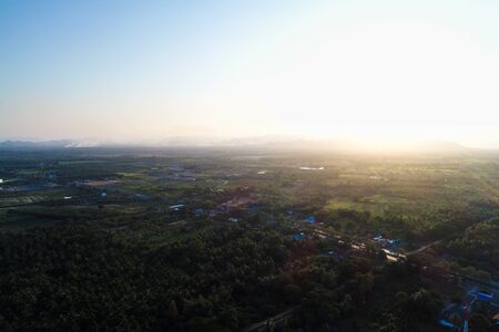 Aerial view morning sunrise rain forest with villagenature landscapeの写真素材