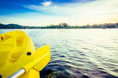 Kayaking at the tropical beach with beautiful sunset, Yellow kayakの写真素材