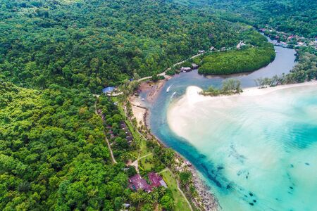 Tropical rainforest sea beach with mountain of palm tree aerial viewの写真素材