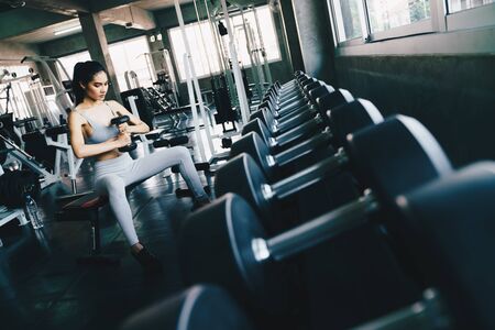 Healthy fitness women lifting dumbbell weight in gym, Sport womenの写真素材