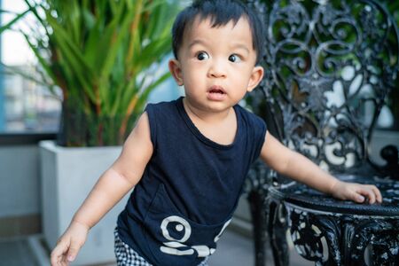 Adorable 1 year baby infant boy practice standing outdoor, Asian baby boyの写真素材