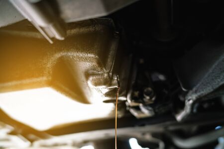 Oil lubricant refill close up of engine under carの写真素材