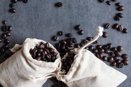 Dark roasted homemade coffee bean on black plate drink industryの写真素材