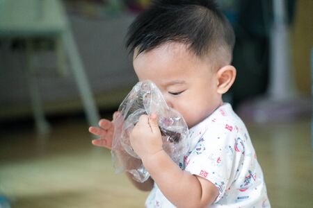 Asian babu boy with chocolate cream dirty on lips of mouth happy baby