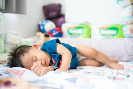 Cute infant asian baby boy sleep on blanket day time, Health care concept