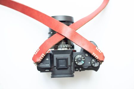 Genuine leather camera strap handmade with mirrorless camera on white background