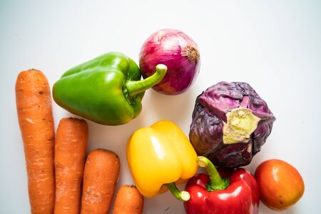Various beta carotene fresh fruit and vegetable on white background top view