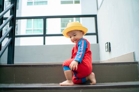 Funny baby boy crawling climbs up stair, Baby developmentの写真素材