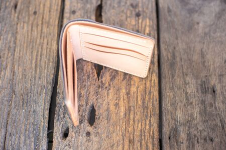 Leather navy blue with white cream wallet handmade working on wood background, Genuine vegetable tanned leatherの写真素材