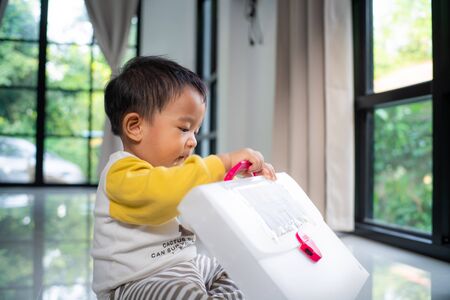 Baby toddler kids boy playing mirror window in modern house, Baby in new house