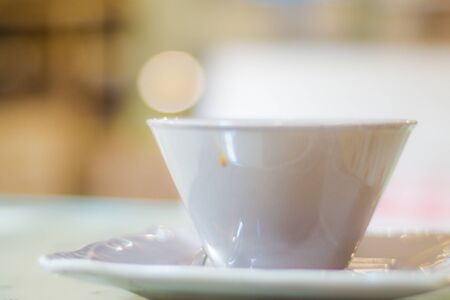 Hot latte coffee in white cup on wood tableの写真素材
