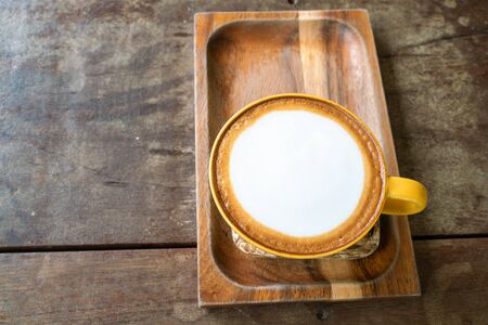 Hot aroma coffee drink latte cup on wood tableの写真素材