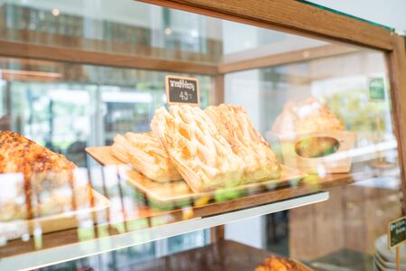 Various sweet bakery with sausage and chocolate in glass box of cafeの写真素材