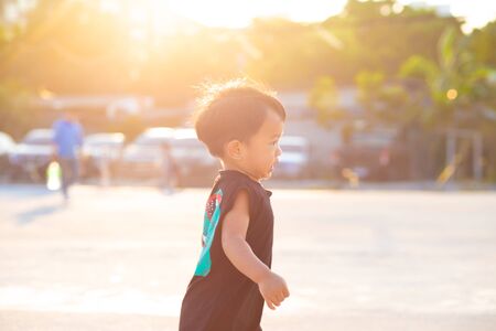 Little toddler asian baby boy walking along playgound outdoor the street new activity experienceの写真素材