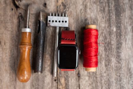 Craft working of leather watch strap on wood table