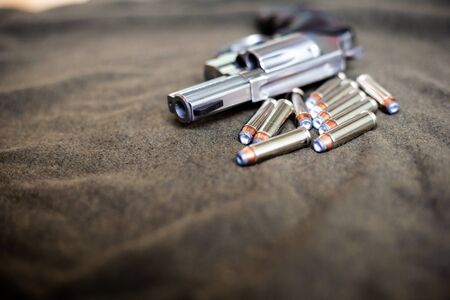 357 magnum revolver classic gun with bullet on cloth background