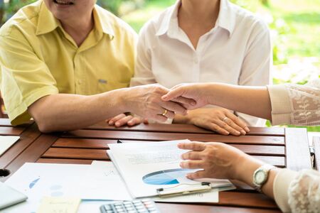 Middle age business group shaking hand success working background with green parkの写真素材