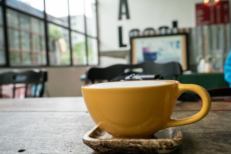 Cup of hot latte art coffee on wood tableの写真素材