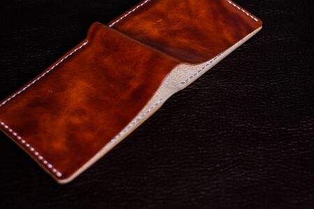 Genuine leather wallet handmade on leather background craftsmanship object