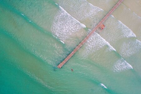Tropical sea wave white sand beach with green tree aerial view in Koh Kood, Thailandの写真素材