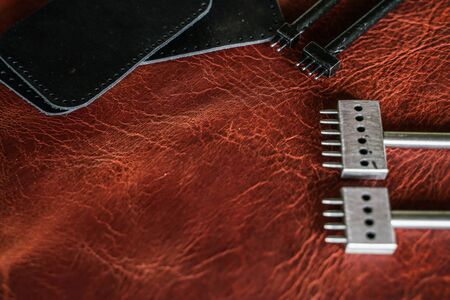 Leather working tool on genuine leather background craftsmanship workingの写真素材