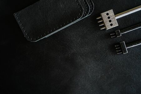 Leather working tool on genuine leather background craftsmanship workingの写真素材