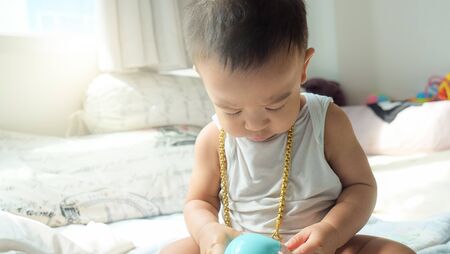 Rich infant baby boy with gold necklace ornament decoration fashion kidの写真素材