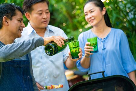 BBQ party group of senior people picnic in park retirement partyの写真素材