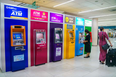 BANGKOK, THAILAND - July 12, 2019: Tourist people using Automated Teller Machines (ATMs) multiple banking services at Don Mueang Airport is one of two international airports serving greater Bangkok, Thailandのeditorial素材