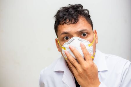 Young asian man wear N95 mask protect dusk and COVID 19 on white background, Healthy man conceptの写真素材