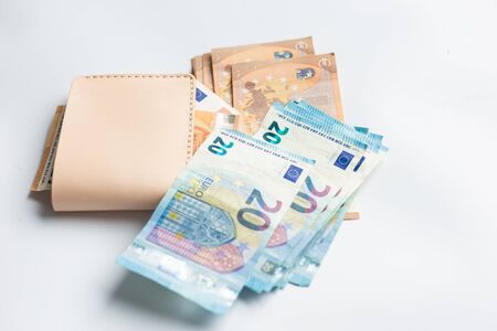 Euro money bill in leather bifold wallet on white background various money note
