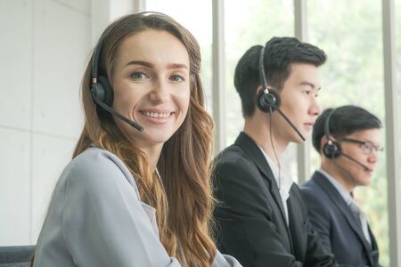 Business call center men and women team service 24 hour working on computer selective focusの写真素材