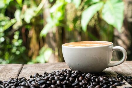 Latte art coffee cup with coffee bean on wood table drink industry object